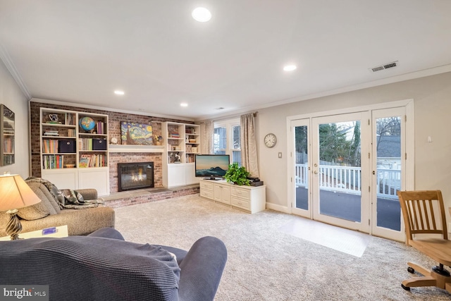 living room featuring light colored carpet, a fireplace, ornamental molding, and a healthy amount of sunlight