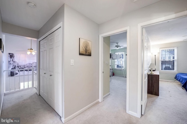 corridor featuring light colored carpet