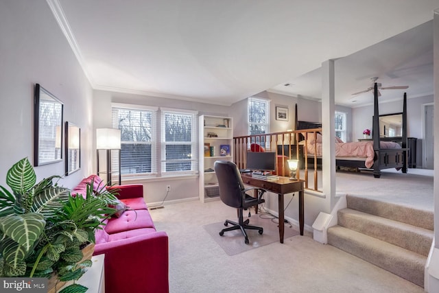 carpeted home office featuring crown molding and a wealth of natural light