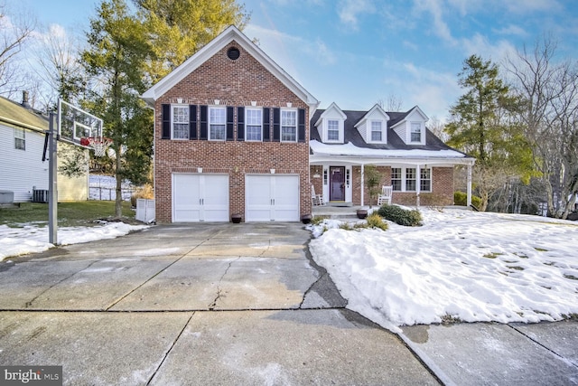 view of front of home featuring a garage and central AC unit