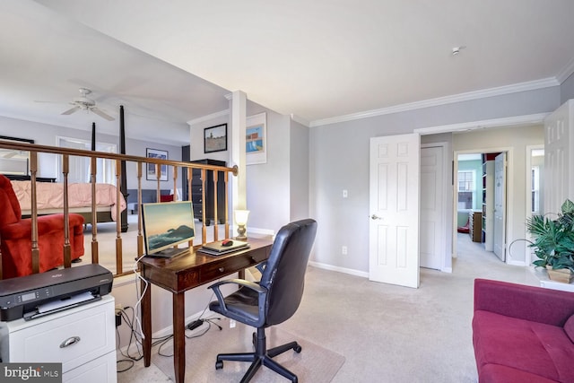 carpeted home office featuring ornamental molding and ceiling fan