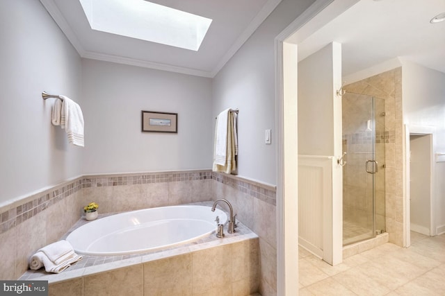 bathroom with tile patterned flooring, a skylight, ornamental molding, and shower with separate bathtub