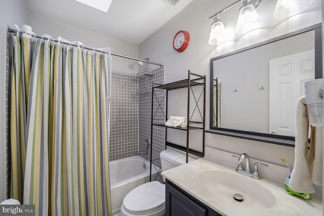 full bathroom with vanity, a skylight, shower / bath combination with curtain, and toilet