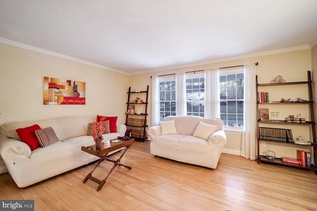 living room with crown molding and light hardwood / wood-style floors