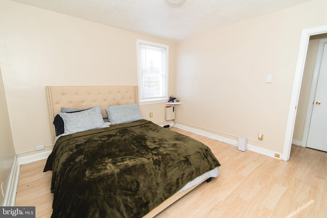 bedroom featuring light wood-type flooring and baseboards