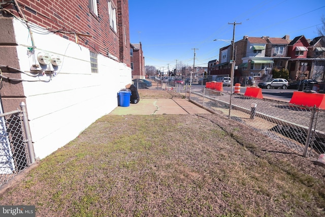 view of yard featuring fence and a residential view