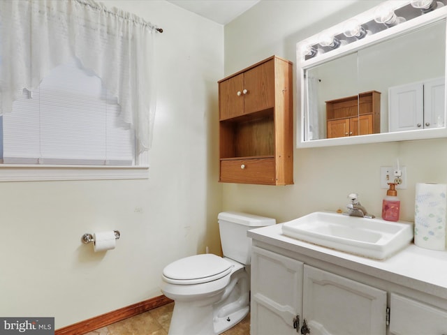 bathroom with vanity, tile patterned floors, and toilet