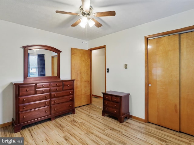 bedroom featuring ceiling fan, a closet, and light wood-type flooring