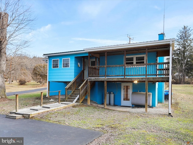 rear view of house with a wooden deck