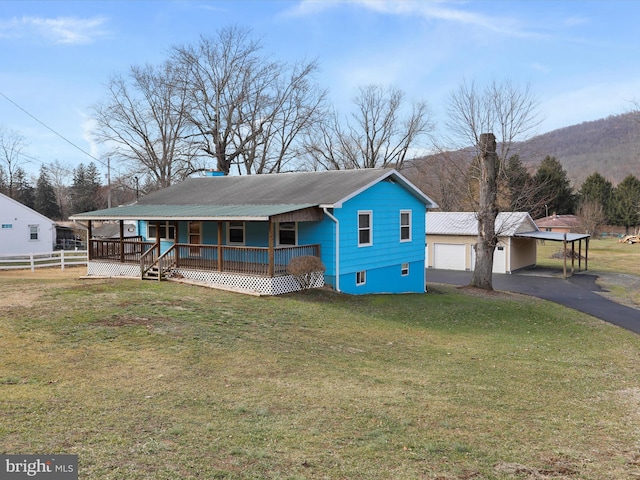 view of front of home featuring a front yard, a carport, and a porch