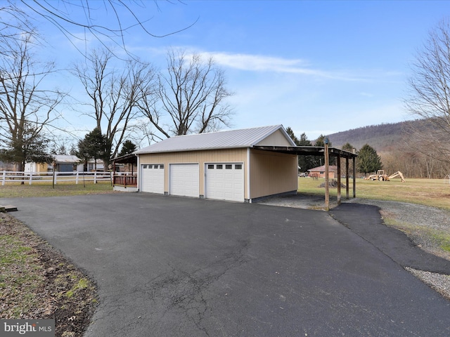 garage with a mountain view and a carport