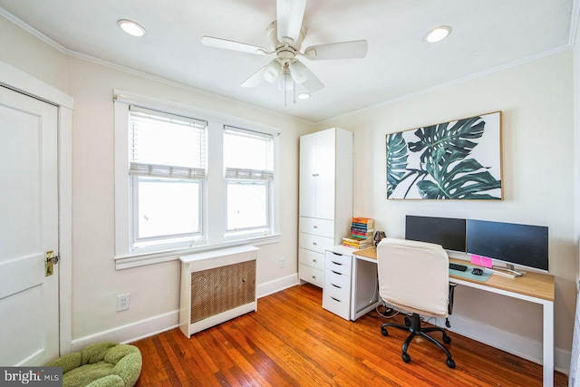 home office featuring radiator, crown molding, ceiling fan, and hardwood / wood-style flooring