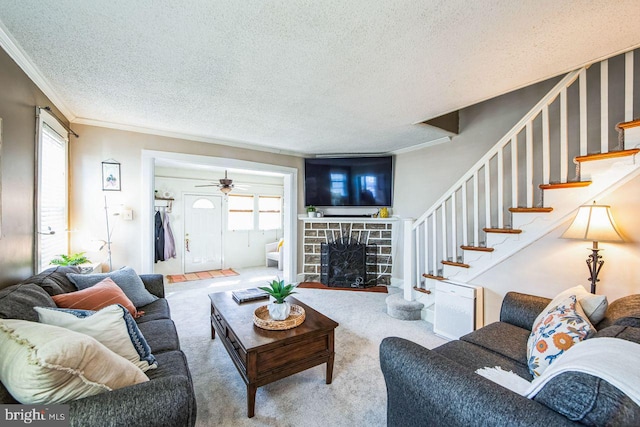 living room featuring carpet floors, ornamental molding, and a textured ceiling