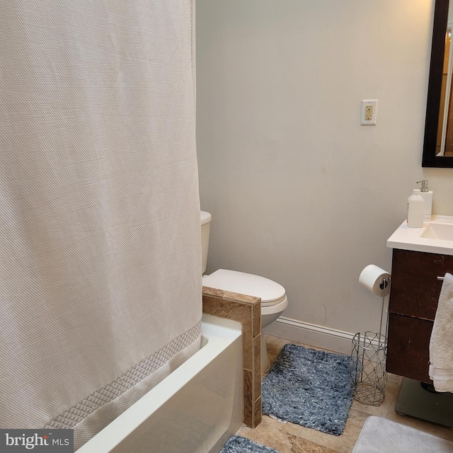 bathroom with tile patterned flooring, vanity, a washtub, and toilet