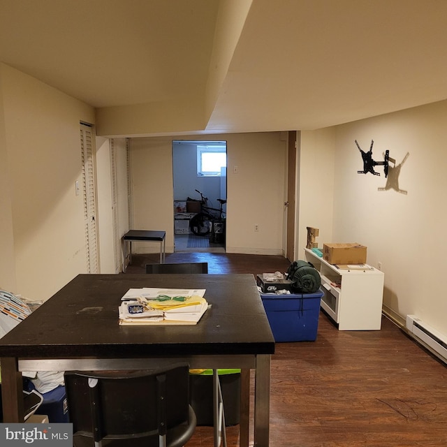 dining space featuring baseboard heating and dark hardwood / wood-style floors