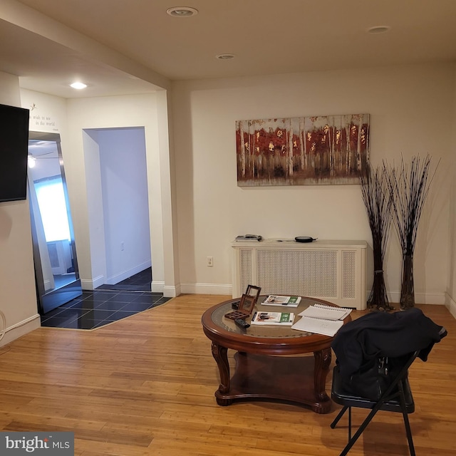 sitting room with wood-type flooring