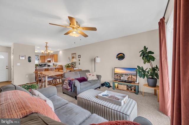 carpeted living room with ceiling fan with notable chandelier