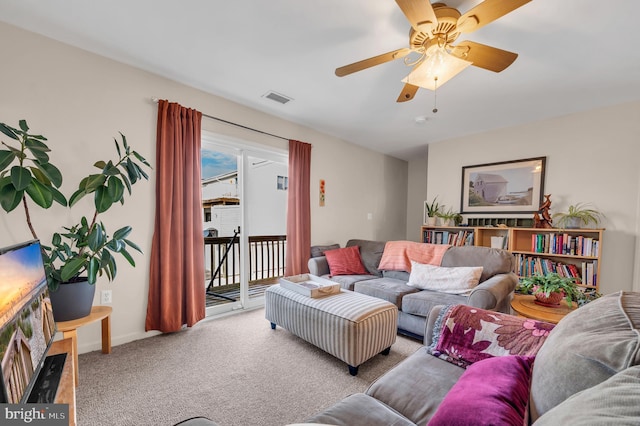 carpeted living room with ceiling fan