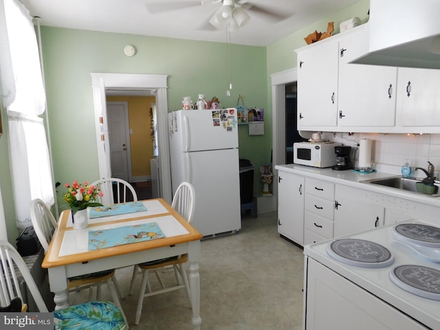 kitchen with white cabinetry, sink, backsplash, ceiling fan, and white appliances