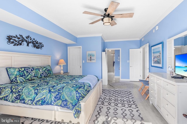 bedroom featuring ornamental molding, ceiling fan, and light wood-type flooring