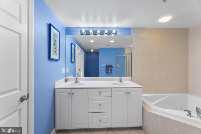 bathroom with tile patterned flooring, plus walk in shower, and vanity