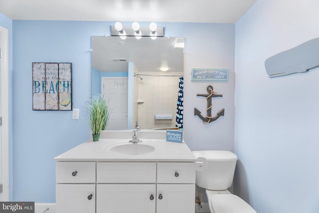 bathroom featuring vanity, curtained shower, and toilet