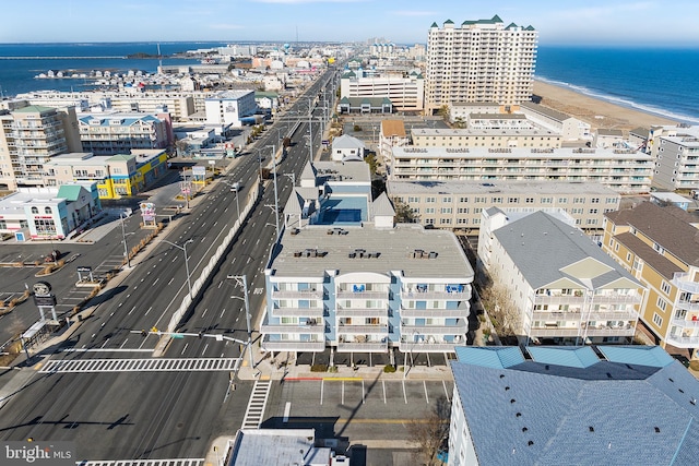 drone / aerial view featuring a water view and a view of the beach