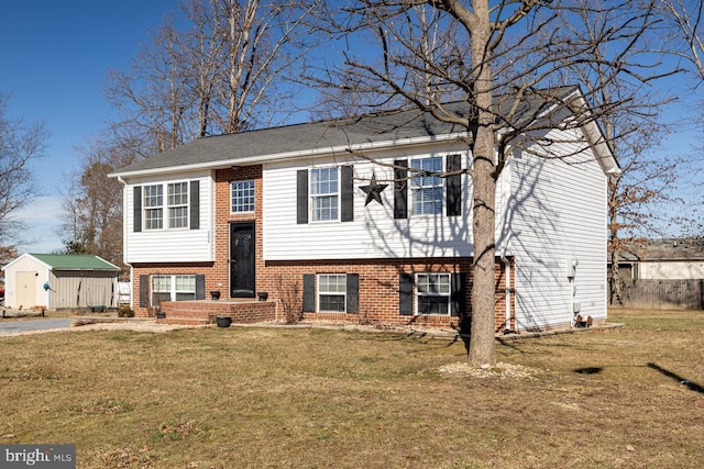 bi-level home with a front lawn and a storage unit