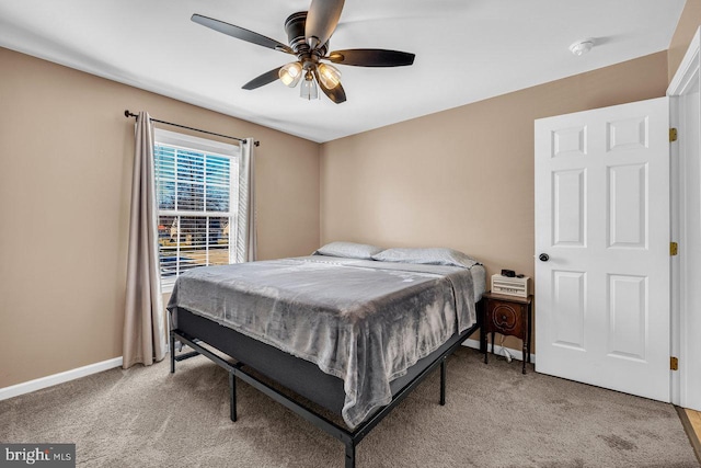 bedroom featuring light carpet and ceiling fan