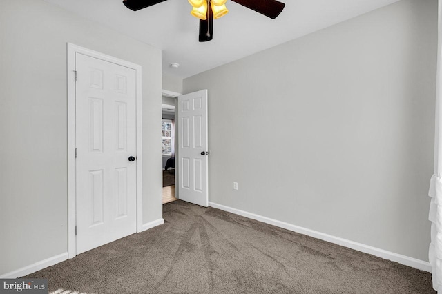 unfurnished bedroom featuring ceiling fan and carpet