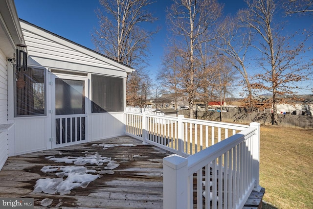 wooden deck with a yard and a sunroom