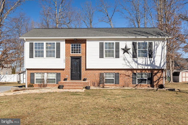 raised ranch with a storage shed and a front lawn