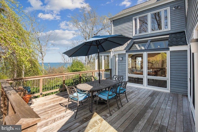 wooden deck featuring outdoor dining area