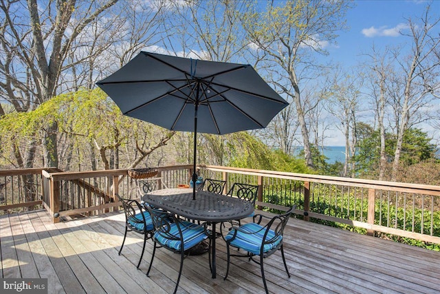 wooden terrace featuring outdoor dining space