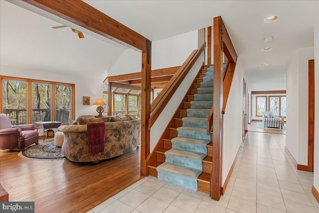 stairs with recessed lighting, lofted ceiling with beams, baseboards, and tile patterned floors