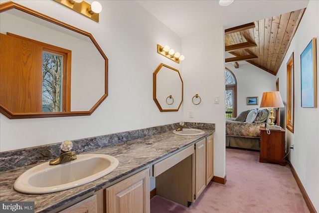 bathroom featuring double vanity, wood ceiling, a sink, baseboards, and ensuite bath