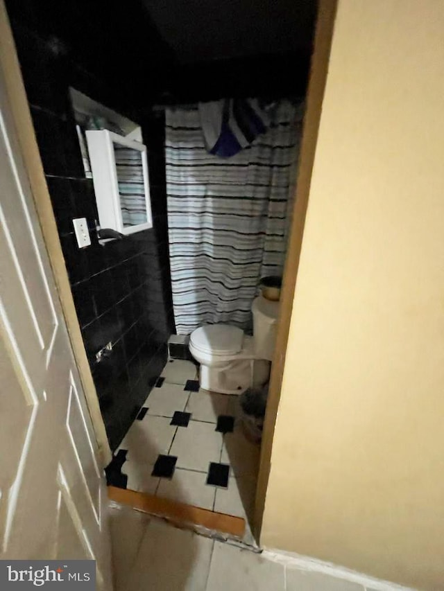 bathroom with tile patterned floors and toilet