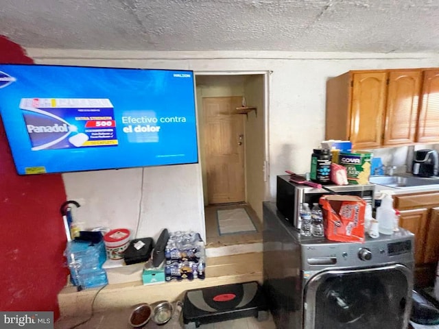 interior space featuring cabinets and a textured ceiling