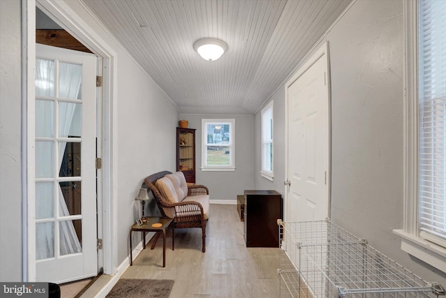 sitting room featuring ornamental molding and light hardwood / wood-style floors