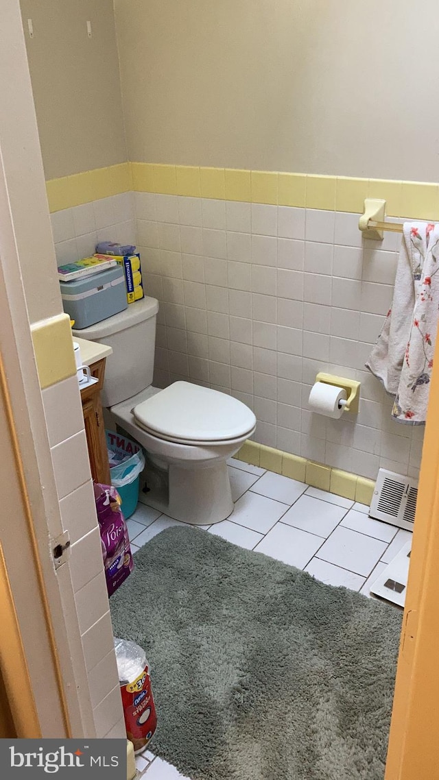 bathroom featuring vanity, tile walls, tile patterned floors, and toilet