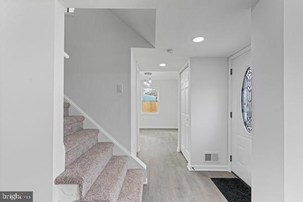 entryway with light hardwood / wood-style flooring