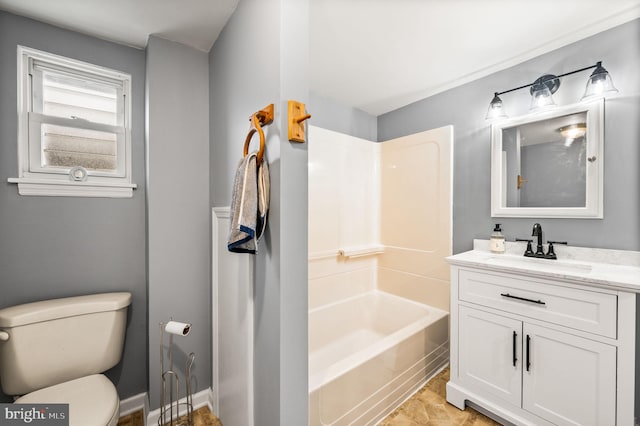 full bathroom featuring washtub / shower combination, vanity, and toilet