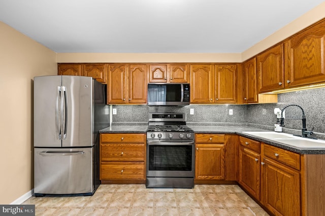 kitchen featuring appliances with stainless steel finishes, sink, and backsplash