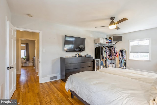 bedroom with ceiling fan and hardwood / wood-style floors