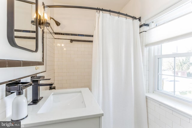 bathroom with a shower with curtain, vanity, and tile walls