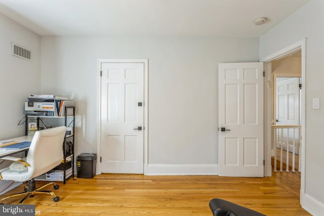 office with light hardwood / wood-style flooring