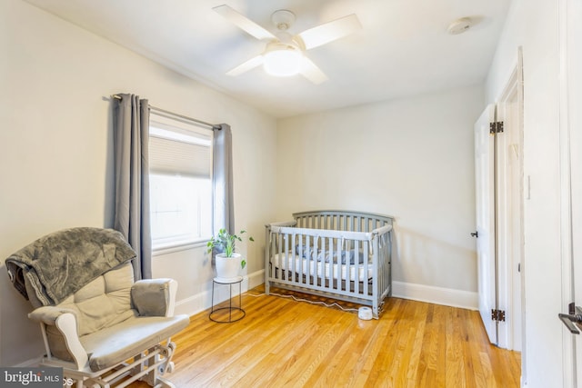 bedroom with light hardwood / wood-style flooring and ceiling fan