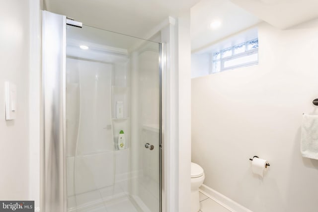 bathroom featuring tile patterned flooring, an enclosed shower, and toilet