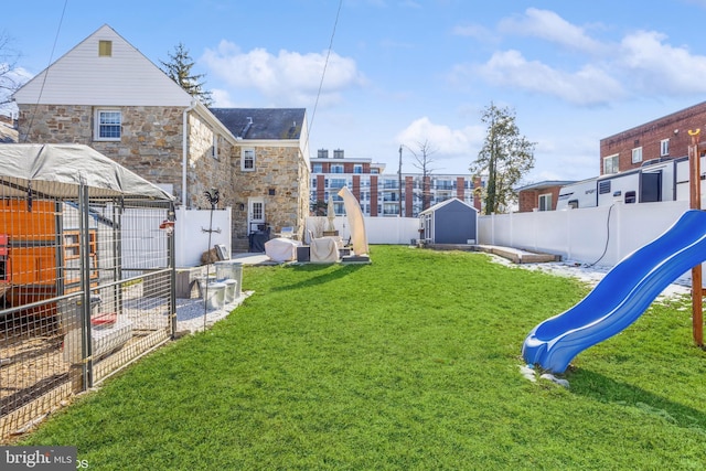 view of yard featuring a playground and a storage shed