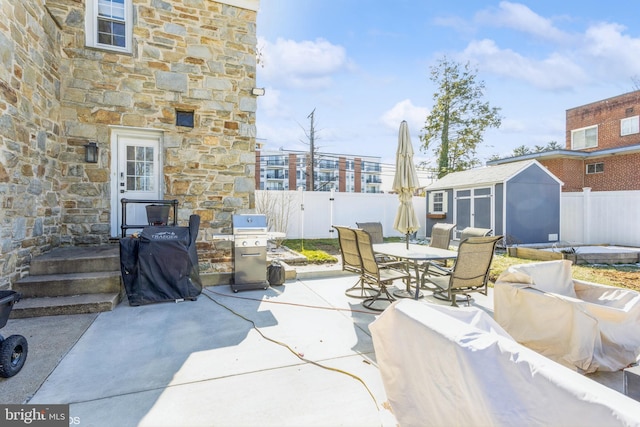 view of patio / terrace with a grill, outdoor lounge area, and a shed